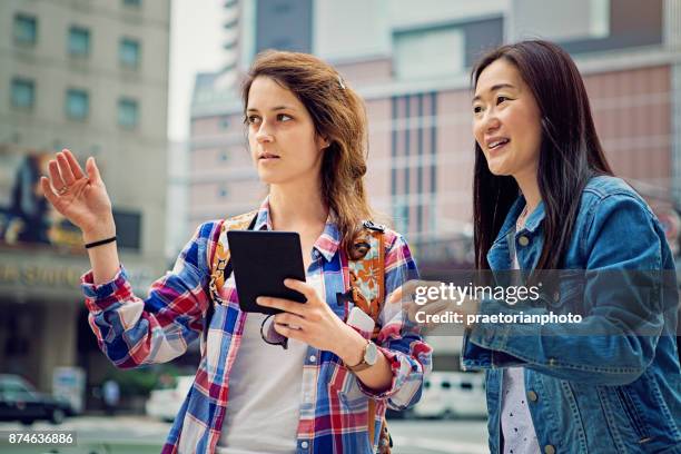 young caucasian girl is lost in japan and asking local mature woman for help - tourist asking stock pictures, royalty-free photos & images