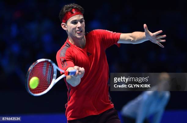 Austria's Dominic Thiem returns to Spain's Pablo Carreno Busta during their men's singles round-robin match on day four of the ATP World Tour Finals...