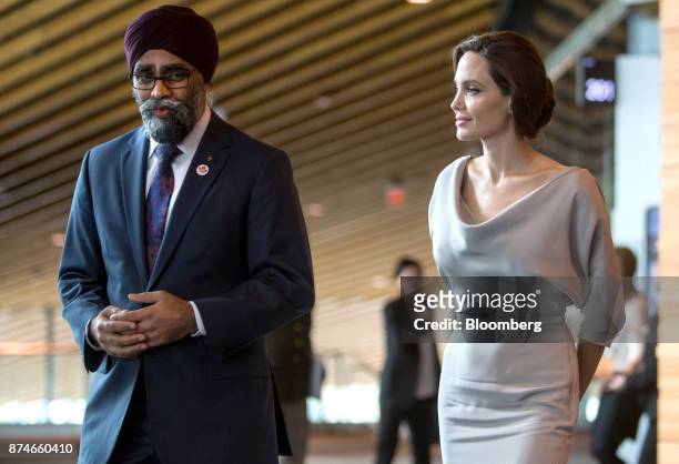 Harjit Sajjan, Canada's defense minister, left, speaks with actress Angelina Jolie, special envoy to the United Nations High Commissioner for...