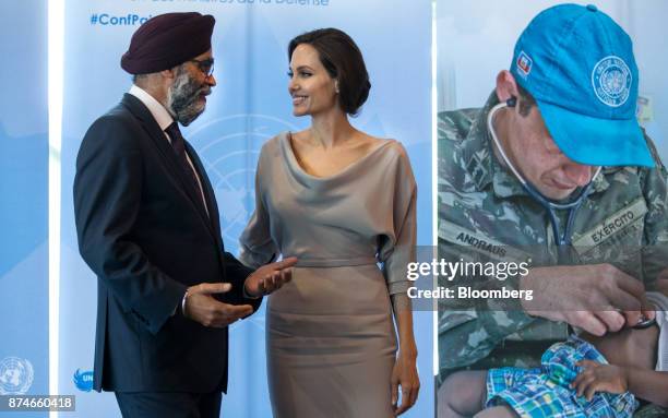 Harjit Sajjan, Canada's defense minister, left, speaks with actress Angelina Jolie, special envoy to the United Nations High Commissioner for...