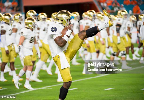 Notre Dame Quarterback Brandon Wimbush holds a football as he warms up during the college football game between the Notre Dame Fighting Irish and the...