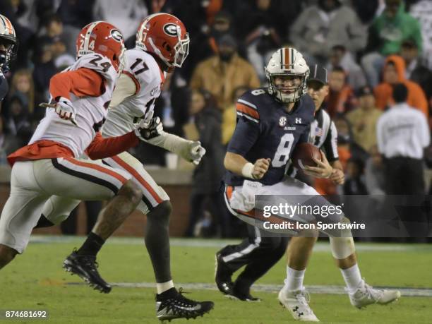 Georgia Bulldogs linebacker Davin Bellamy and Georgia Bulldogs defensive back Dominick Sanders pursues Auburn Tigers quarterback Jarrett Stidham as...