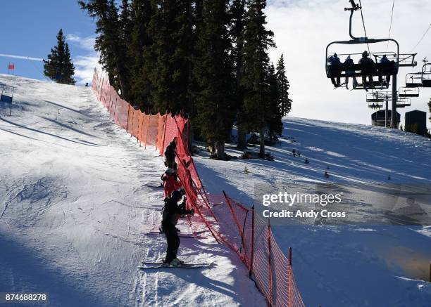 Course workers score safety netting along the course underneath the Super Bee lift at the U.S. Ski Team Speed Center at Copper Mountain November 15,...