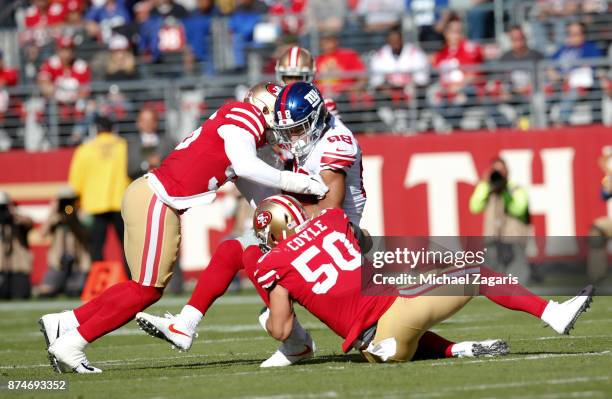 Reuben Foster and Brock Coyle of the San Francisco 49ers tackle Evan Engram of the New York Giants during the game at Levi's Stadium on November 12,...