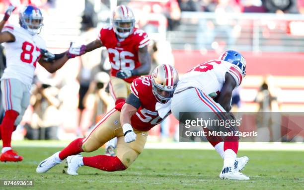 Brock Coyle of the San Francisco 49ers tackles Orleans Darkwa of the New York Giants during the game at Levi's Stadium on November 12, 2017 in Santa...