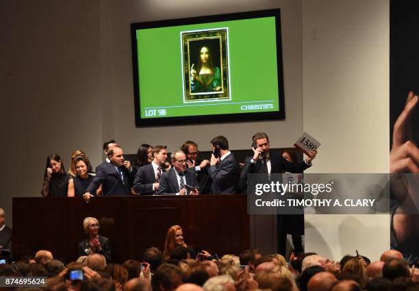 Christie's employees take bids for Leonardo da Vinci's "Salvator Mundi" at Christie's New York November 15, 2017. A 500-year-old work of art...