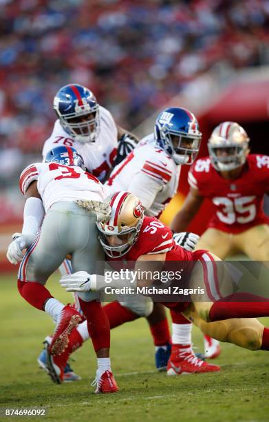 Brock Coyle of the San Francisco 49ers tackles Shane Vereen of the New York Giants during the game at Levi's Stadium on November 12, 2017 in Santa...