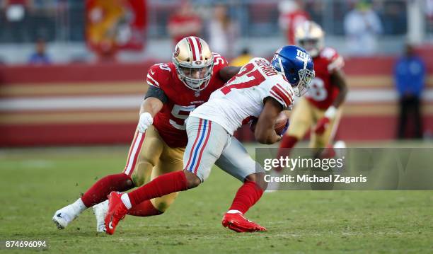 Brock Coyle of the San Francisco 49ers tackles Sterling Shepard of the New York Giants during the game at Levi's Stadium on November 12, 2017 in...