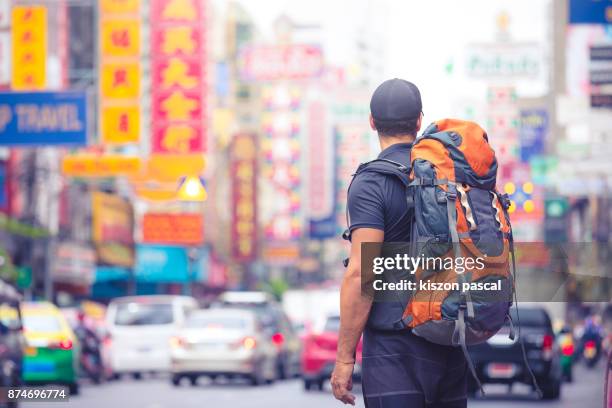 tourist backpacker visiting a city in southeast asia . . - mochilero fotografías e imágenes de stock
