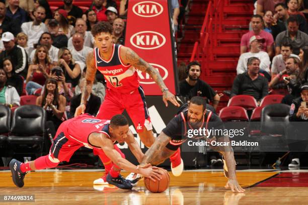 Tim Frazier of the Washington Wizards and AJ Hammons of the Miami Heat wrestle for ball on November 15, 2017 at American Airlines Arena in Miami,...