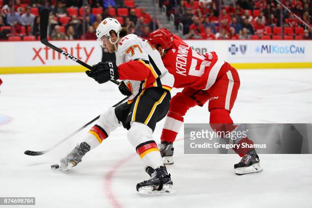 Mark Jankowski of the Calgary Flames tries to control the puck in front of Niklas Kronwall of the Detroit Red Wings during the first period at Little...