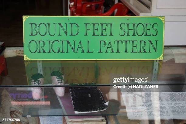 display of foot binding shoes | melaka | malaysia - foot binding stock pictures, royalty-free photos & images