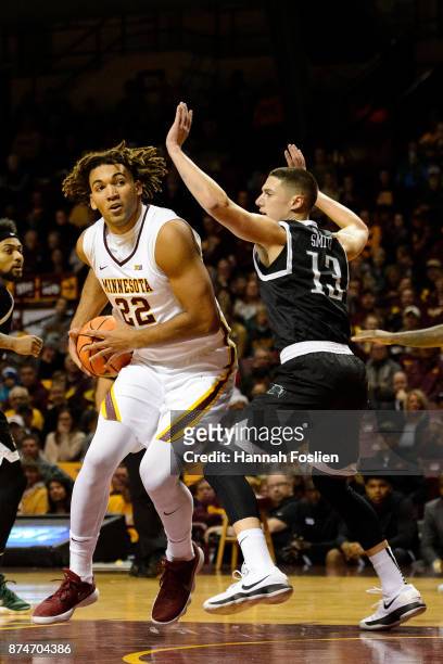 Reggie Lynch of the Minnesota Golden Gophers shoots the ball against Carson Smith of the USC Upstate Spartans during the game on November 10, 2017 at...