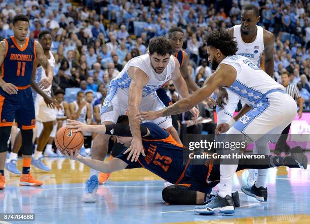Zach Thomas of the Bucknell Bison loses the ball as he drives against Luke Maye and Joel Berry II of the North Carolina Tar Heels during their game...