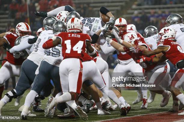 Ian Eriksen of the Eastern Michigan Eagles dives over the line of scrimmage just short of a touchdown against the Miami Ohio Redhawks during the...