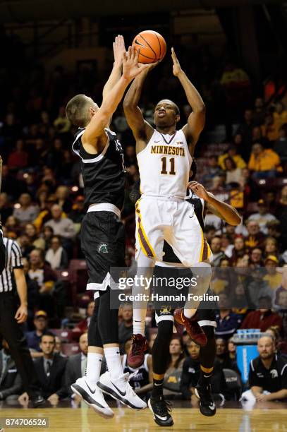 Isaiah Washington of the Minnesota Golden Gophers shoots the ball against Carson Smith of the USC Upstate Spartans during the game on November 10,...