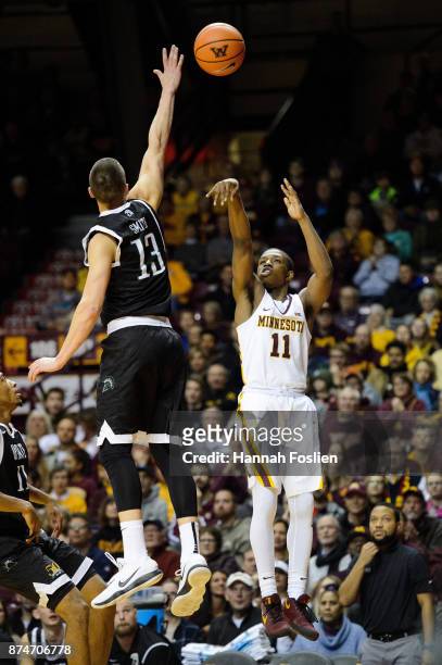 Isaiah Washington of the Minnesota Golden Gophers shoots the ball against Carson Smith of the USC Upstate Spartans during the game on November 10,...