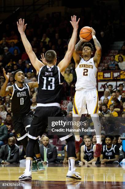 Nate Mason of the Minnesota Golden Gophers shoots the ball against Carson Smith of the USC Upstate Spartans during the game on November 10, 2017 at...