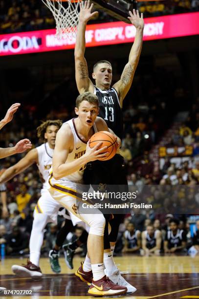 Carson Smith of the USC Upstate Spartans defends against Michael Hurt of the Minnesota Golden Gophers during the game on November 10, 2017 at...