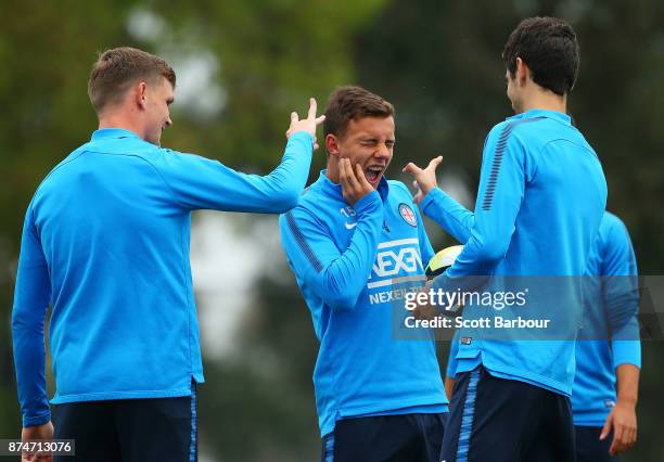 Denis Genreau reacts as Michael Jakobsen flicks his ear as Iacopo La Rocca looks on during a Melbourne City A-League training session on November 16,...