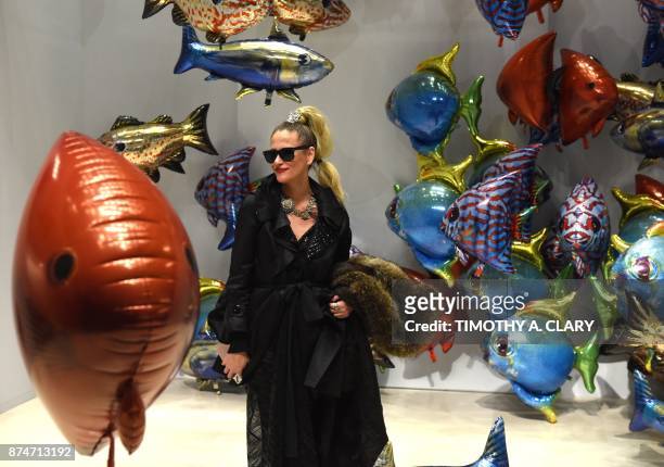Woman looks at the art of Philippe Parreno titled "My Room Is Another Fish Bowl" at Christie's New York November 15, 2017. / AFP PHOTO / TIMOTHY A....