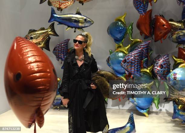 Woman looks at the art of Philippe Parreno titled "My Room Is Another Fish Bowl" at Christie's New York November 15, 2017. / AFP PHOTO / TIMOTHY A....