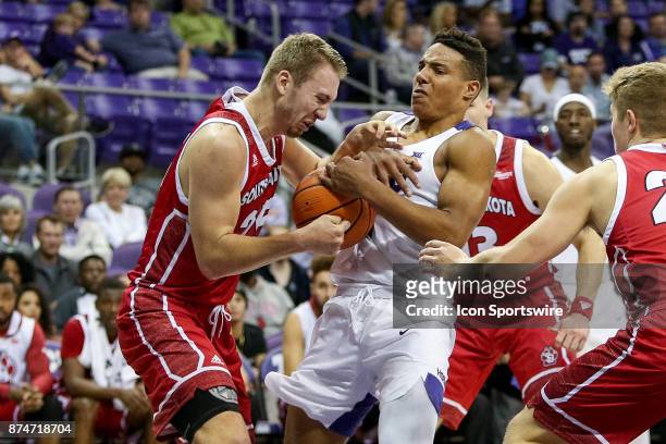 Horned Frogs guard Desmond Bane and South Dakota Coyotes forward Tyler Hagedorn fight for a loose ball during the game between the South Dakota...