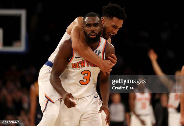 Tim Hardaway Jr. #3 of the New York Knicks is congratulated by teammate Courtney Lee after Hardaway Jr. Hit a three point shot in the final minutes...