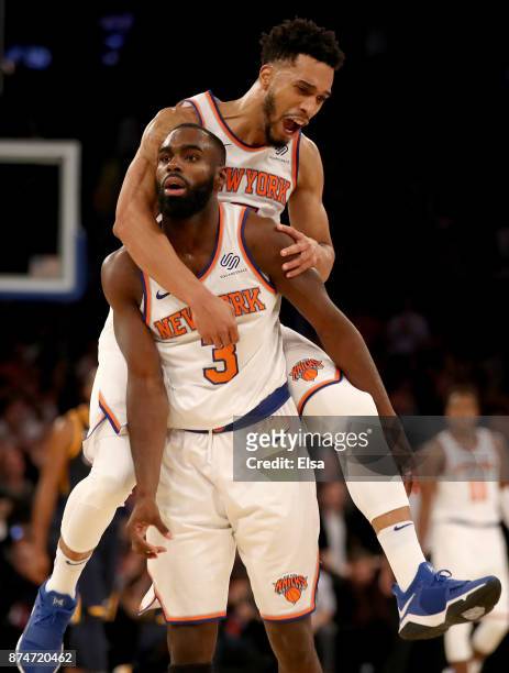 Tim Hardaway Jr. #3 of the New York Knicks is congratulated by teammate Courtney Lee after Hardaway Jr. Hit a three point shot in the final minutes...