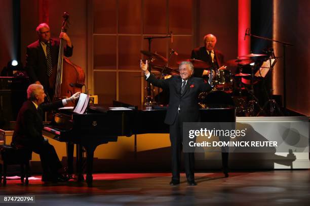 Singer Tony Bennett raises his hands during his performance at the Library of Congress Gershwin Prize Tribute Concert in his honor in Washington, DC...