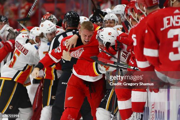 Anthony Mantha of the Detroit Red Wings gets in a fight with Travis Hamonic of the Calgary Flames during the third period at Little Caesars Arena on...