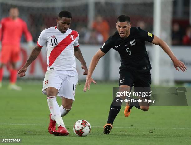 Jefferson Farfan of Peru and Michael Boxall of New Zealand compete for the ball during a second leg match between Peru and New Zealand as part of the...