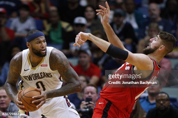 DeMarcus Cousins of the New Orleans Pelicans drives against Jonas Valanciunas of the Toronto Raptors during the second half of a game at the Smoothie...