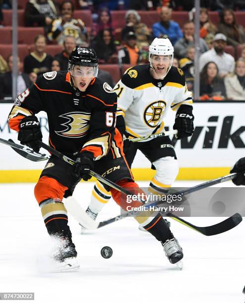 Kevin Roy of the Anaheim Ducks prepares to shoot a rolling puck for his first NHL goal in front of Jordan Szwarz the Boston Bruins, to take a 1-0...