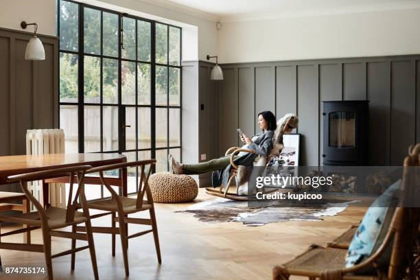 taking a browse at the many pregnancy apps online - rocking chair stock pictures, royalty-free photos & images