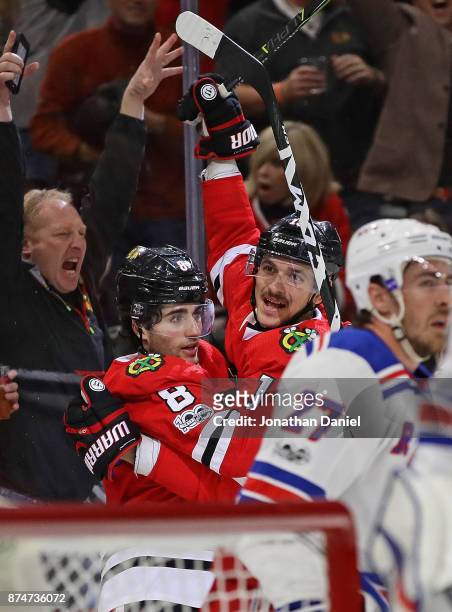 Nick Schmaltz and Artem Anisimov of the Chicago Blackhawks celebrate Anisimovs' third goal of the game against the New York Rangers at the United...