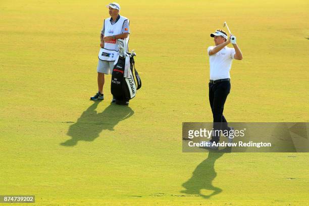 Ian Poulter of England hits an approach shot on the 3rd hole during the first round of the DP World Tour Championship at Jumeirah Golf Estates on...