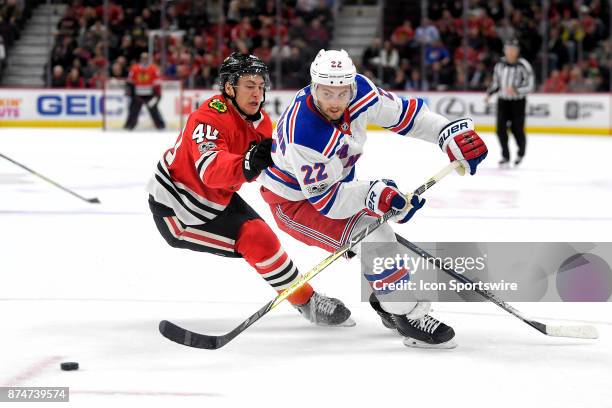 New York Rangers defenseman Kevin Shattenkirk battles with Chicago Blackhawks right wing John Hayden in the third period during a game between the...