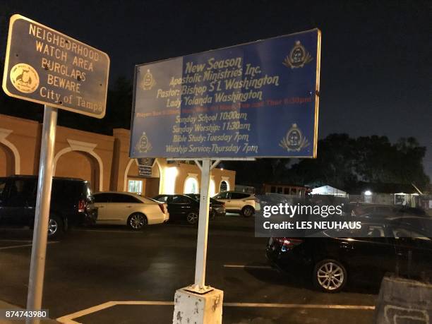 Sign warning burglars to beware is seen beside a church notice late November 15, 2017 in Tampa, Florida, with fears mounting over a possible serial...