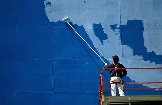 Man painting billboard