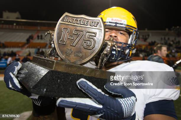 Toledo Rockets defensive tackle Marquise Moore holds the Battle of I-75 trophy at the conclusion of the game between the Toledo Rockets and the...