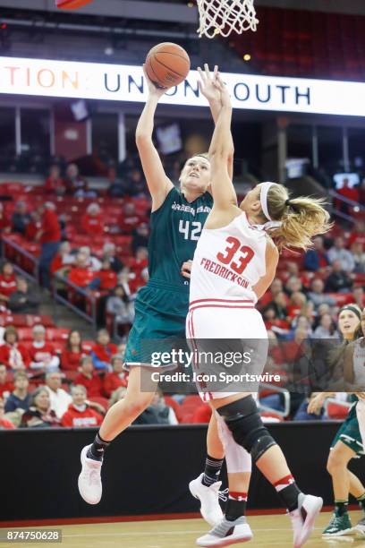 Green Bay Phoenix Forward/Center Mackenzie Wolf scores over Wisconsin Badger Forward/Center Courtney Fredrickson during an college women's basketball...