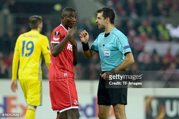 Sehrou Guirassy of Koeln speaks with Referee Aleksandar Stavrev during the UEFA Europa League group H match between 1. FC Koeln and BATE Borisov at...