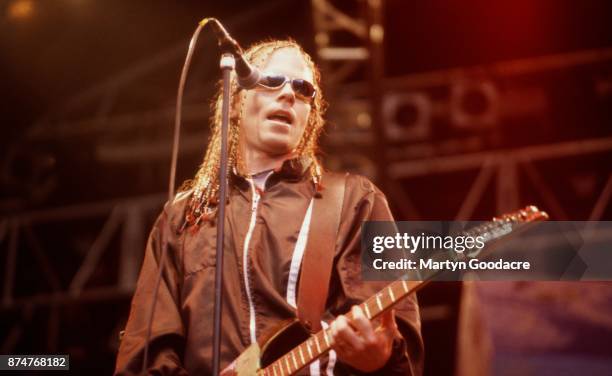 American singer Dexter Holland of Offspring performs on stage, United Kingdom, circa 1995.