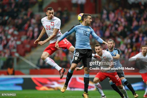 Jaroslaw Jach of Poland and Matias Vecino of Uruguay during international friendly match between Poland and Uruguay at National Stadium on November...