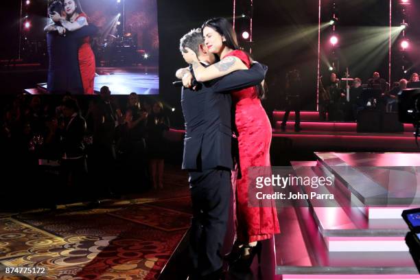 Honoree Alejandro Sanz greets Mon Laferte onstage during the 2017 Person of the Year Gala honoring Alejandro Sanz at the Mandalay Bay Convention...