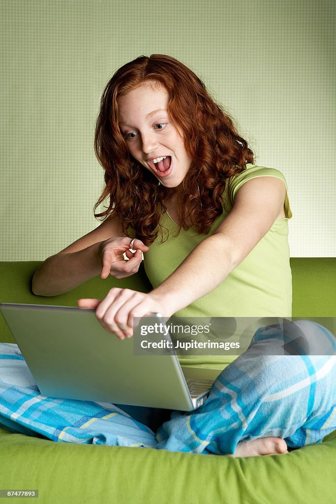 Shocked teenager with laptop computer