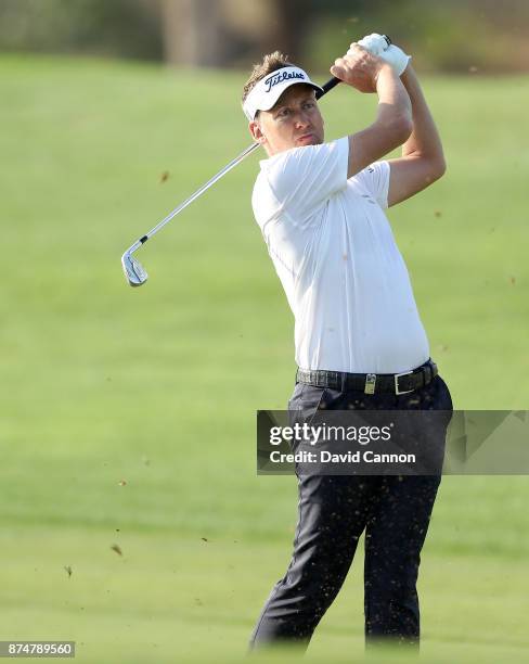 Ian Poulter of England plays his second shot on the third hole during the first round of the DP World Tour Championship on the Earth Course at...