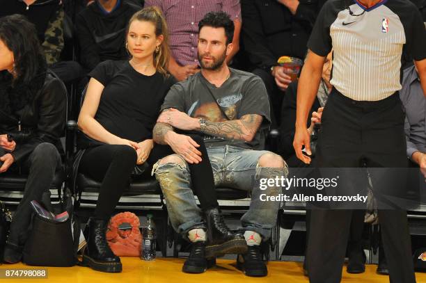 Model Behati Prinsloo and singer Adam Levine attend a basketball game between the Los Angeles Lakers and the Philadelphia 76ers at Staples Center on...