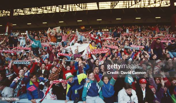 Liverpool supporters wave their scarves in the 'Kop End' during a First Division match against Manchester United on Aapril 26, 1992 in Liverpool,...